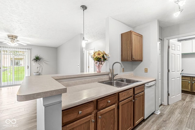 1044 Timber Creek Dr Unit 2, Carmel, IN 46032 - kitchen with dishwasher, a textured ceiling, light wood-style flooring, a ceiling fan, and a peninsula