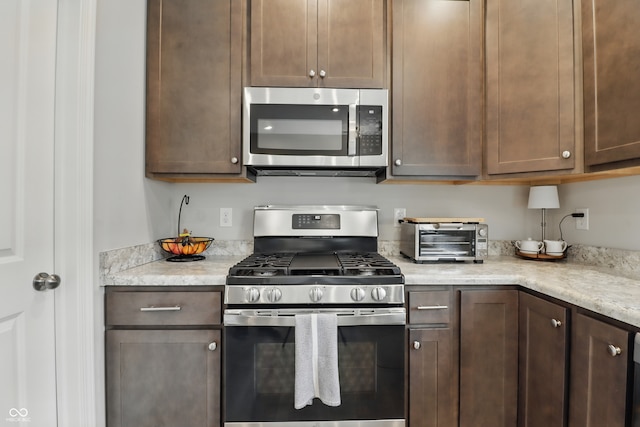 3613 Lehigh Ave, Westfield, IN 46074 - kitchen with stainless steel appliances and dark brown cabinetry
