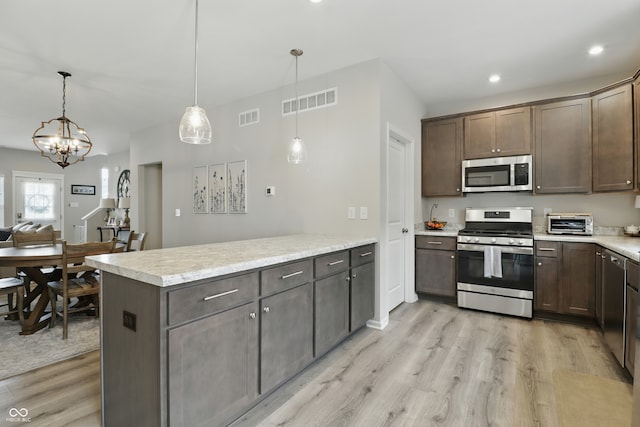 3613 Lehigh Ave, Westfield, IN 46074 - kitchen featuring appliances with stainless steel finishes, light wood-style floors, a peninsula, dark brown cabinets, and recessed lighting