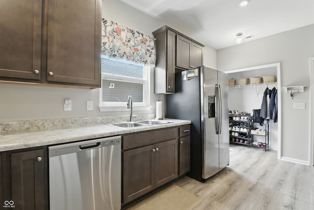 3613 Lehigh Ave, Westfield, IN 46074 - kitchen with appliances with stainless steel finishes, dark brown cabinetry, and light wood-style flooring