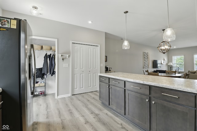 3613 Lehigh Ave, Westfield, IN 46074 - kitchen featuring stainless steel fridge, light wood-style flooring, decorative light fixtures, open floor plan, and recessed lighting