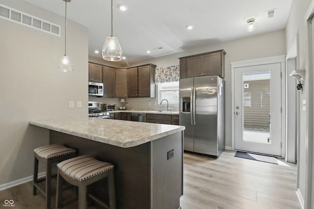 3613 Lehigh Ave, Westfield, IN 46074 - kitchen with stainless steel appliances, dark brown cabinets, recessed lighting, a peninsula, and light countertops