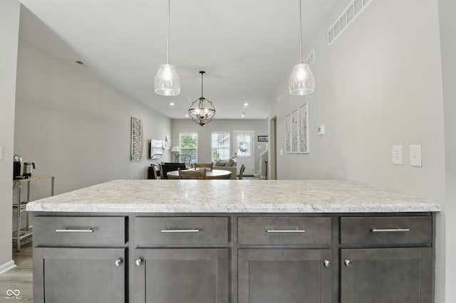 3613 Lehigh Ave, Westfield, IN 46074 - kitchen with dark brown cabinets, light wood-type flooring, hanging light fixtures, and open floor plan