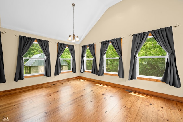 5800 S Shore Dr, Nashville, IN 47448 - unfurnished room with a chandelier, lofted ceiling, and hardwood / wood-style floors