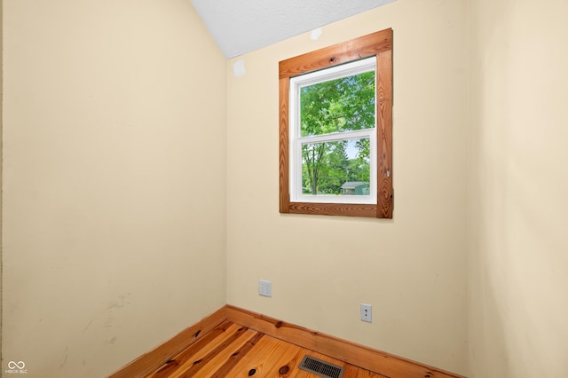 5800 S Shore Dr, Nashville, IN 47448 - empty room with lofted ceiling and light wood-style floors
