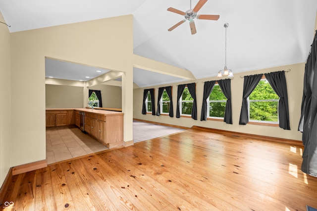 5800 S Shore Dr, Nashville, IN 47448 - unfurnished living room featuring light wood-style floors, ceiling fan, high vaulted ceiling, and a chandelier