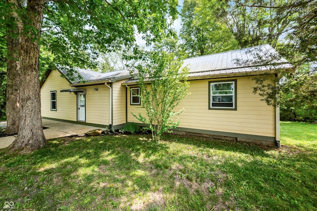 5800 S Shore Dr, Nashville, IN 47448 - view of front of house featuring a patio area, a metal roof, and a front yard