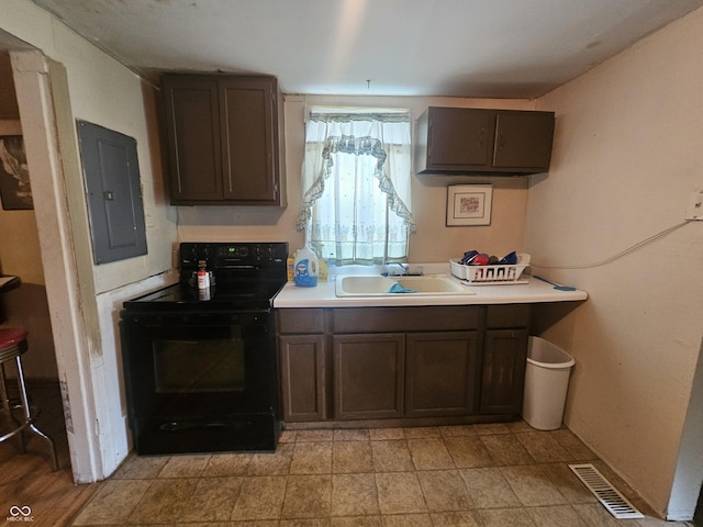 1102 S Dequincy St, Indianapolis, IN 46203 - kitchen with black electric range, a sink, electric panel, and light countertops