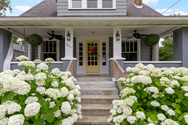 4813 E 11th St, Indianapolis, IN 46201 - doorway to property with ceiling fan, a porch, a shingled roof, and a chimney