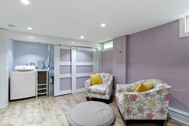 4813 E 11th St, Indianapolis, IN 46201 - sitting room with concrete block wall, washing machine and clothes dryer, light wood-type flooring, and recessed lighting
