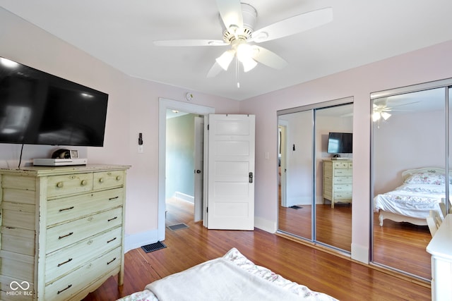 4813 E 11th St, Indianapolis, IN 46201 - bedroom featuring multiple closets, wood finished floors, and a ceiling fan