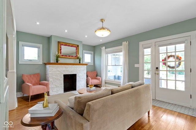 4813 E 11th St, Indianapolis, IN 46201 - living room with wood-type flooring, a fireplace, and recessed lighting