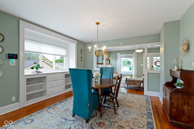 4813 E 11th St, Indianapolis, IN 46201 - dining room featuring wood finished floors and a chandelier