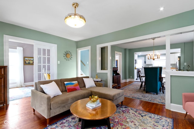 4813 E 11th St, Indianapolis, IN 46201 - living area featuring wood finished floors, a chandelier, and stairs