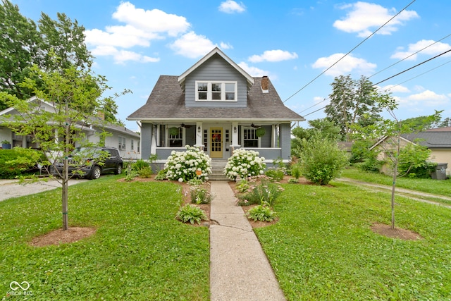 4813 E 11th St, Indianapolis, IN 46201 - bungalow-style home with a front lawn, a ceiling fan, a porch, and roof with shingles