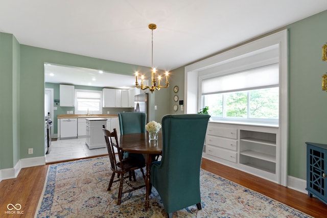 4813 E 11th St, Indianapolis, IN 46201 - dining area with light wood-type flooring, a chandelier, and recessed lighting
