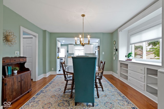 4813 E 11th St, Indianapolis, IN 46201 - dining room featuring a chandelier, wood finished floors, and healthy amount of natural light