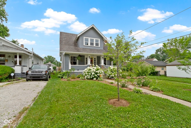4813 E 11th St, Indianapolis, IN 46201 - bungalow-style home with covered porch, a front yard, and gravel driveway