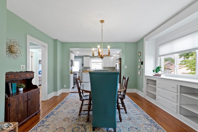 4813 E 11th St, Indianapolis, IN 46201 - dining area featuring a chandelier and dark wood-style floors
