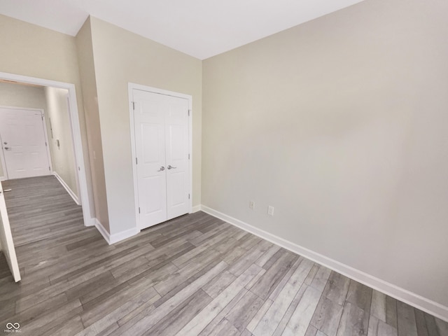 1359 Shadow Ridge Rd, Indianapolis, IN 46280 - unfurnished bedroom featuring wood finished floors, a closet, and baseboards