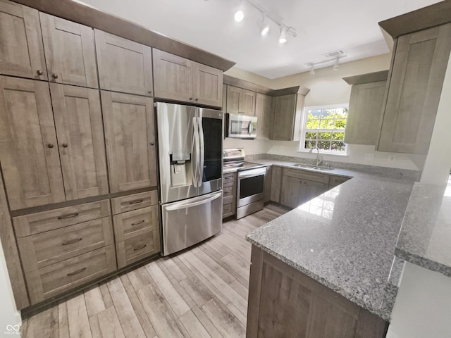 1359 Shadow Ridge Rd, Indianapolis, IN 46280 - kitchen with stainless steel appliances, a peninsula, light stone countertops, and light wood finished floors