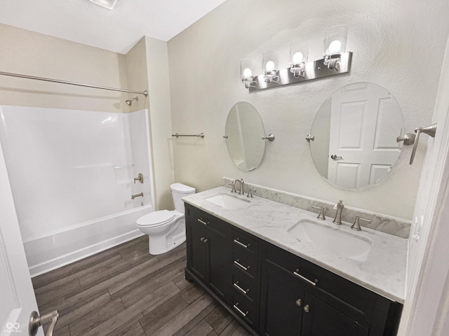 1359 Shadow Ridge Rd, Indianapolis, IN 46280 - bathroom featuring toilet, wood finished floors, double vanity, and washtub / shower combination