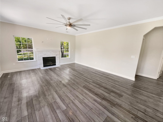 1359 Shadow Ridge Rd, Indianapolis, IN 46280 - unfurnished living room featuring a ceiling fan, dark wood-type flooring, a stone fireplace, and crown molding