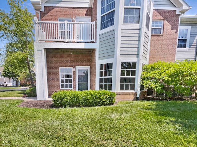 1359 Shadow Ridge Rd, Indianapolis, IN 46280 - view of home's exterior with a balcony, brick siding, and a yard
