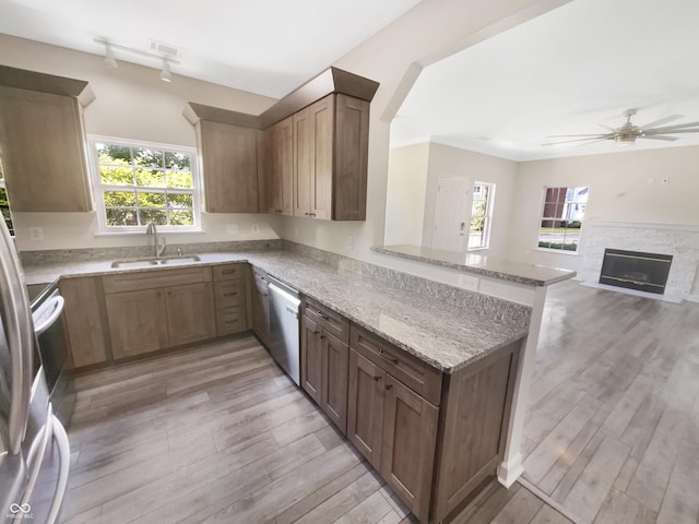 1359 Shadow Ridge Rd, Indianapolis, IN 46280 - kitchen with a sink, a peninsula, stainless steel dishwasher, a ceiling fan, and light wood-style flooring