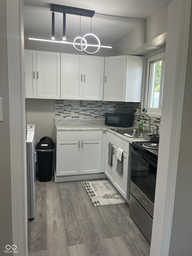 880 N Avon Ave, Avon, IN 46123 - kitchen featuring stainless steel range with electric cooktop, white cabinets, and tasteful backsplash