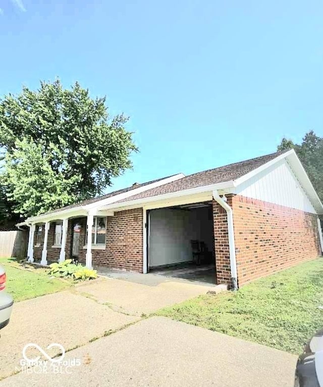 731 Sunset Blvd, Greenwood, IN 46142 - view of property exterior featuring an attached garage, brick siding, concrete driveway, and a lawn