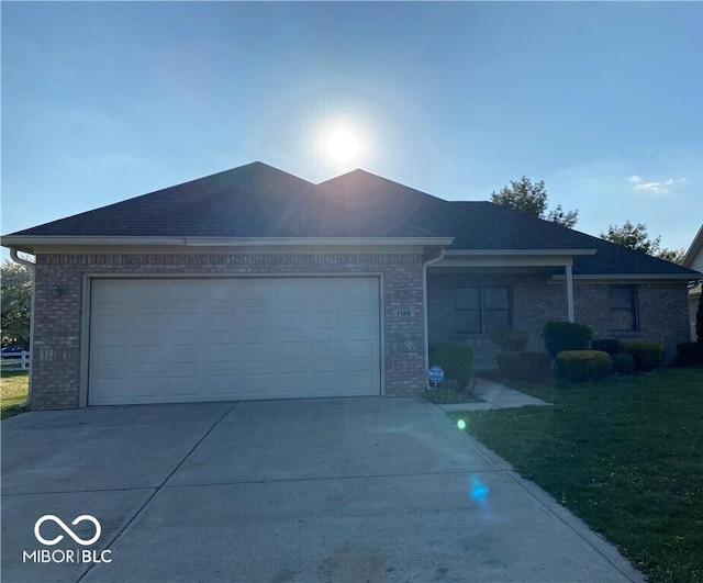 1128 Brookside Ct, Avon, IN 46123 - single story home with brick siding, an attached garage, driveway, and a front yard