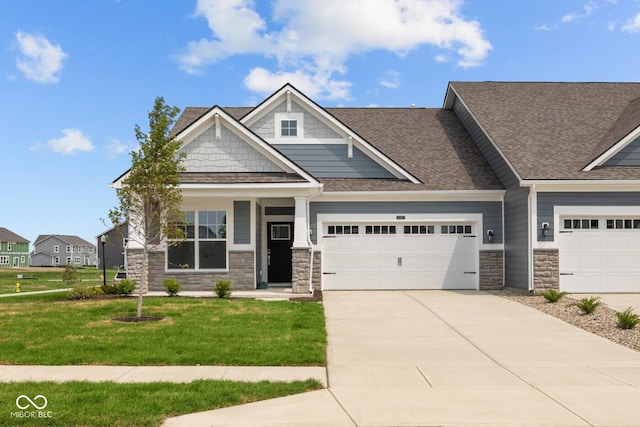 12490 Morning Ridge Way, Noblesville, IN 46060 - craftsman-style home featuring stone siding, concrete driveway, a front lawn, a garage, and roof with shingles