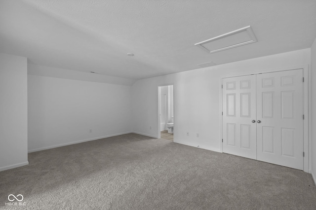 12490 Morning Ridge Way, Noblesville, IN 46060 - unfurnished bedroom with attic access, carpet floors, a closet, ensuite bathroom, and a textured ceiling