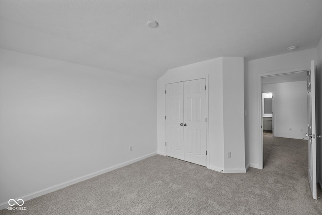 12490 Morning Ridge Way, Noblesville, IN 46060 - unfurnished bedroom featuring carpet, a closet, and vaulted ceiling