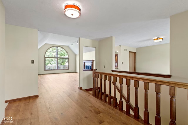 5037 Surrey Ln, Carmel, IN 46033 - hall featuring hardwood / wood-style flooring, lofted ceiling, and an upstairs landing
