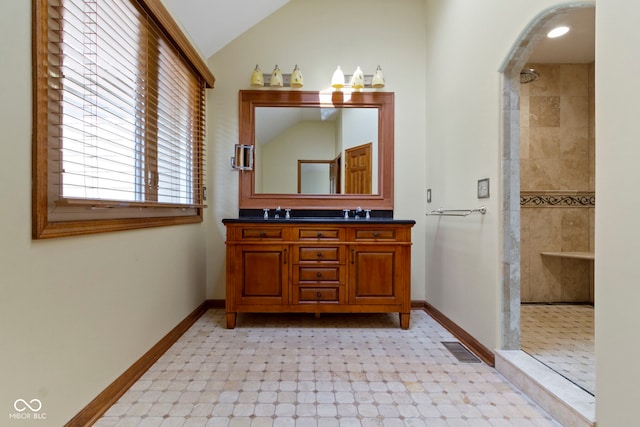 5037 Surrey Ln, Carmel, IN 46033 - bathroom with double vanity, a tile shower, and vaulted ceiling