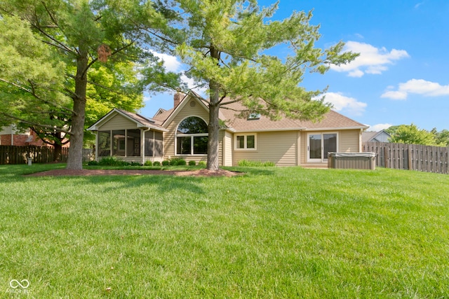5037 Surrey Ln, Carmel, IN 46033 - back of property featuring a chimney, a sunroom, a fenced backyard, and a hot tub