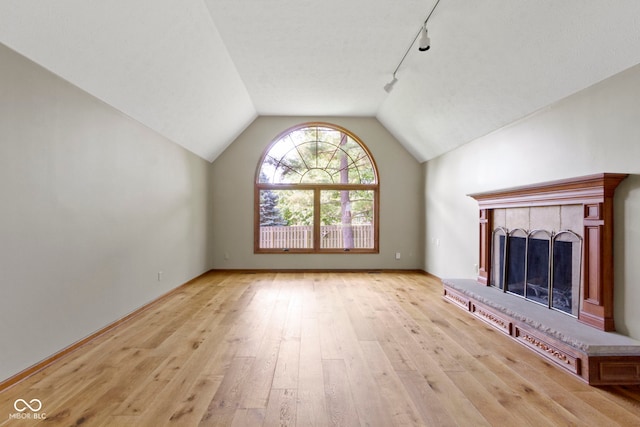 5037 Surrey Ln, Carmel, IN 46033 - unfurnished living room with wood-type flooring, lofted ceiling, a fireplace, and rail lighting