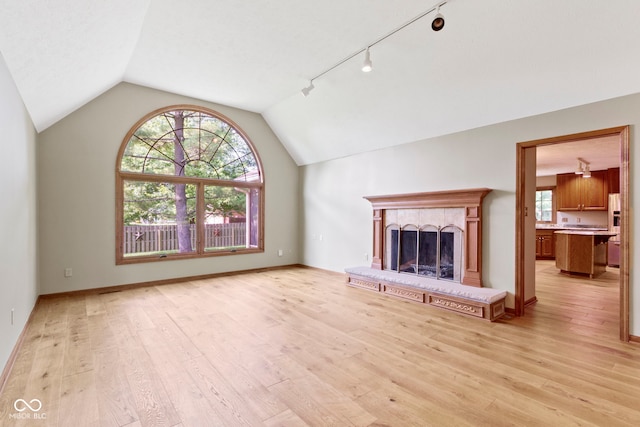 5037 Surrey Ln, Carmel, IN 46033 - unfurnished living room featuring healthy amount of natural light, lofted ceiling, light wood-type flooring, and a brick fireplace