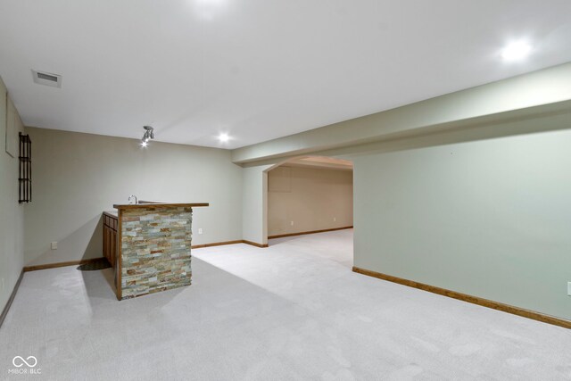 5037 Surrey Ln, Carmel, IN 46033 - finished below grade area featuring bar with sink, light colored carpet, and recessed lighting