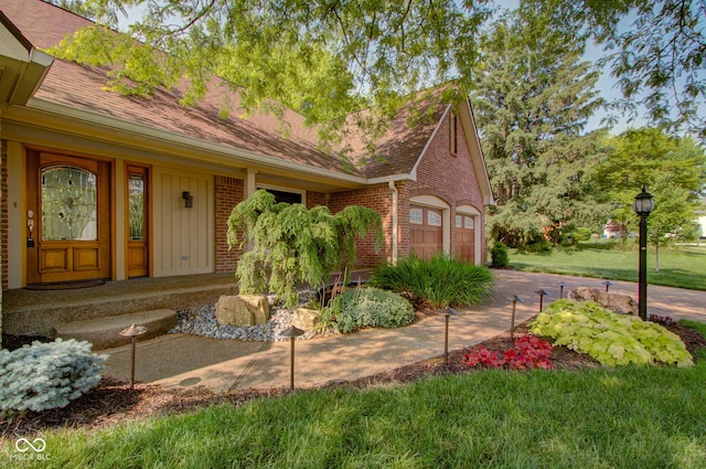 5037 Surrey Ln, Carmel, IN 46033 - view of front of home featuring brick siding, a shingled roof, a garage, and driveway