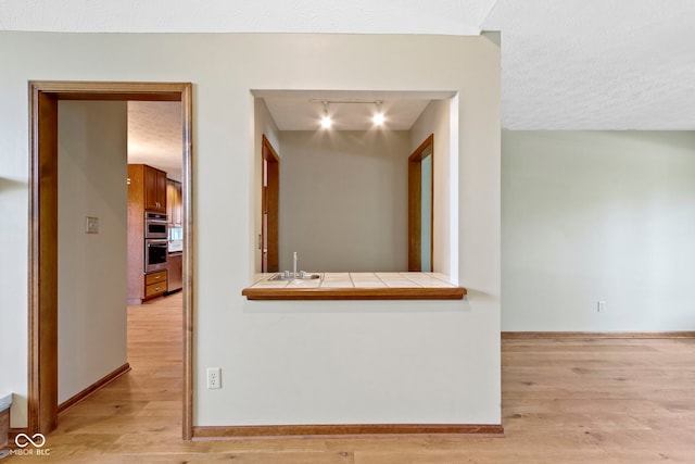 5037 Surrey Ln, Carmel, IN 46033 - hall with light wood-style floors and a textured ceiling