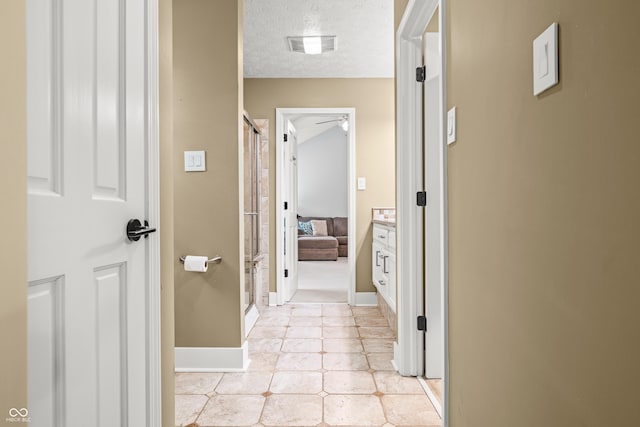 7833 Meadow Bend Dr, Indianapolis, IN 46259 - hall with baseboards, light tile patterned floors, and a textured ceiling