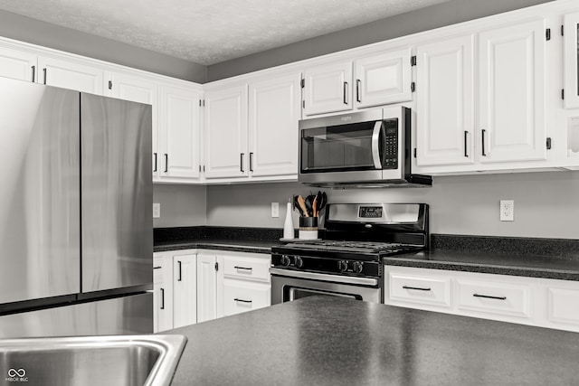 7833 Meadow Bend Dr, Indianapolis, IN 46259 - kitchen with stainless steel appliances, white cabinets, and a textured ceiling