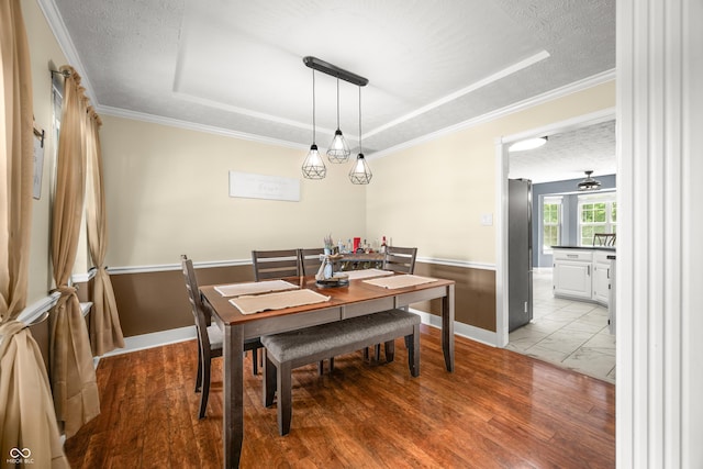 7833 Meadow Bend Dr, Indianapolis, IN 46259 - dining room featuring a tray ceiling, baseboards, marble finish flooring, a textured ceiling, and ornamental molding