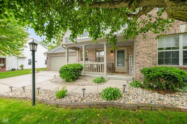 7833 Meadow Bend Dr, Indianapolis, IN 46259 - view of front of house featuring covered porch, brick siding, and driveway