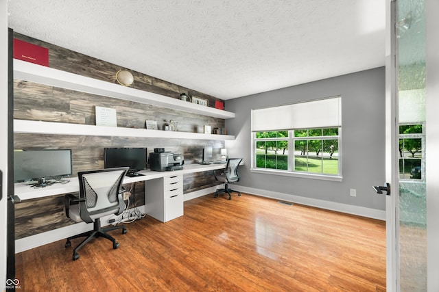 7833 Meadow Bend Dr, Indianapolis, IN 46259 - office featuring built in study area, wood finished floors, baseboards, and a textured ceiling