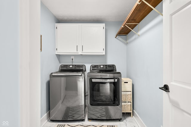 7833 Meadow Bend Dr, Indianapolis, IN 46259 - laundry room featuring light marble finish flooring, washing machine and clothes dryer, baseboards, and cabinet space