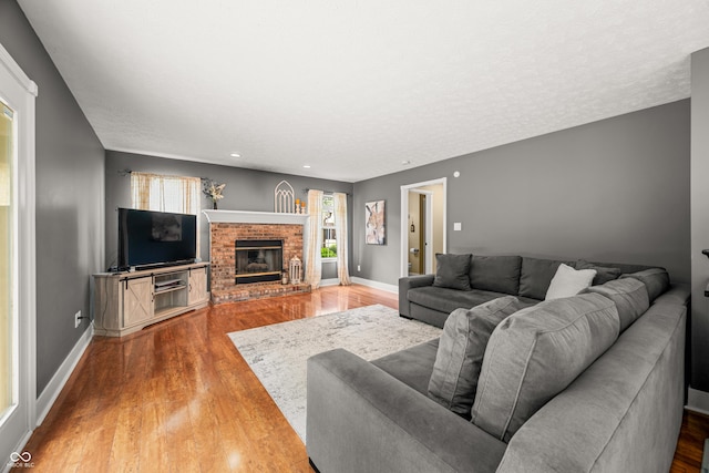 7833 Meadow Bend Dr, Indianapolis, IN 46259 - living room featuring wood finished floors, baseboards, a fireplace, and recessed lighting